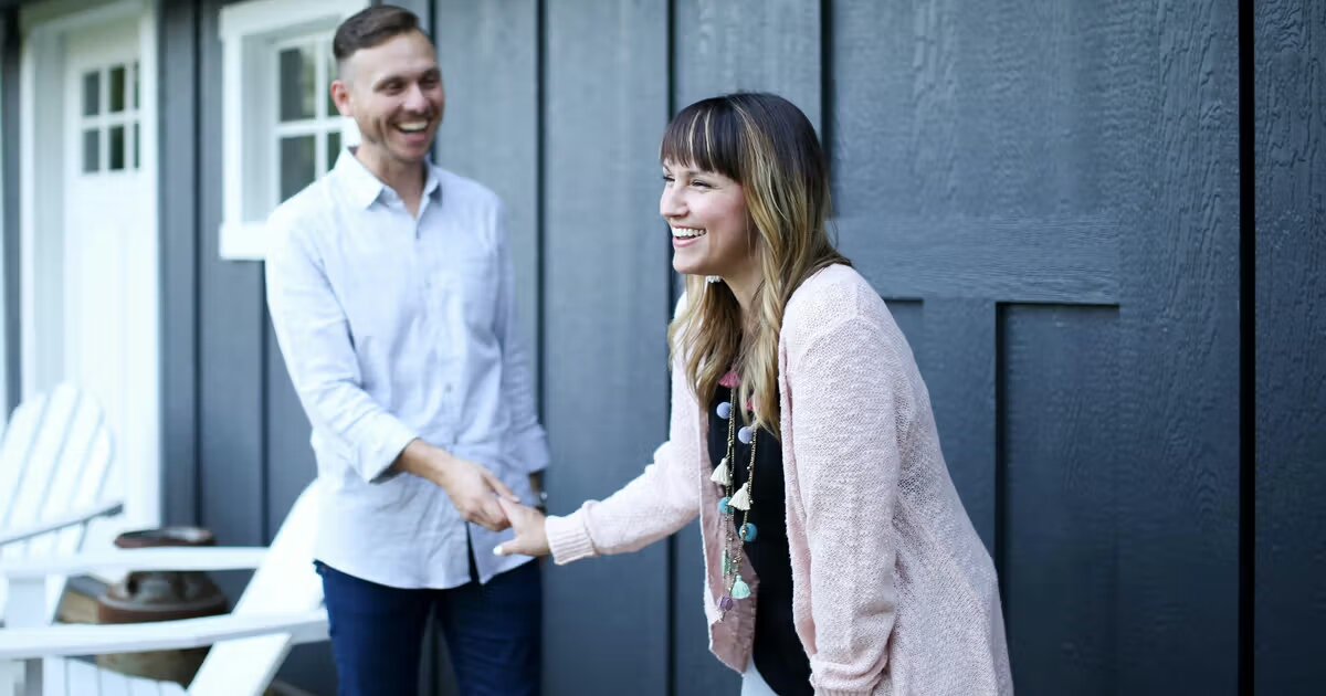 Homeowner shaking hands with a cash buyer after reviewing a no-obligation cash offer
